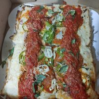 Vegan Detroit style pizza with jalapenos shallot vegan cheeses and vegan pepperoni at Peels On Wheels in Rochester