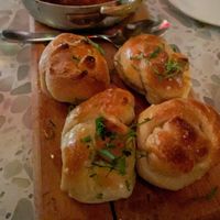 Puttanesca “Meatballs” ($18) - Lemon brown butter sauce, capers, kalamata olives, roma tomatoes, “mozzarella,” parsley garlic knots at Coletta in New York City