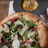 fig and prosciutto pizza + carbonara in back   at Coletta in New York City