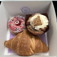 Vanilla/berry cake (top left), cinnamon roll (top right), plain croissant (bottom)   at Purple Horseshoe Baking in Oakville