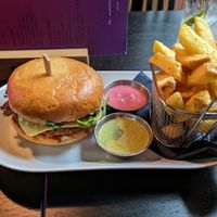 The Klandi burger with fries and green (herbs) and pink (like honey mustard) sauce at Klandestine in Basel