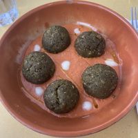 Palotte secondi: veggie and almond balls over tomato sauce with dollops of olive oil and vegan cheese  at L' Angolo Cottura in Rome