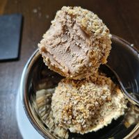 Mozart Eisknödel
Hazelnut-chocolate ice cream balls filled with marzipan, pistachio cream covered in caramelised hazelnut crumbs. at Tisch in Vienna