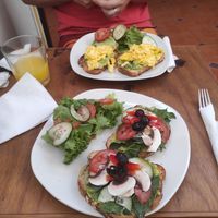 Vegan tostas on my side, vegetarian tostas on the other plate. Awesome fresh juice! at Mercado Local in Oaxaca