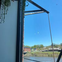 View of the Kennebec out the rear windows! at Cushnoc Brewing Co in Augusta
