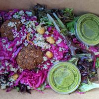 Classic Falafel on mixed greens with tabouli, pickled red cabbage, carrot chickpea salad, & spicy green sauce at Amsterdam Falafel & Kabob in Omaha
