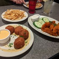Mac and cheese balls, buffalo tenders, fries, and waffle in the background at Veggie Galaxy in Cambridge
