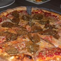 Vegan Pepperoni Pizza with Buffalo Cauliflower wings in the background at Mohawk Bend in Los Angeles