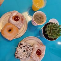 Freshly squeezed orange juice, 2 raspberry jam filled donuts, coconut and chocolate donut, glazed donut (all of them vegan!), coffee. at Pink Love Donuts and More in Miami Beach