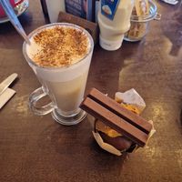Chai latte and chocolate biscoff and vegan kitkat muffin. at Revo Kitchen & Terrace in Weston-super-mare