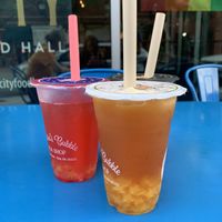 Orange one is the oolong pineapple tea with mango jelly boba. The pink one is strawberry lemonade with strawberry popping boba.  at Andora's Bubble Tea Shop in Erie