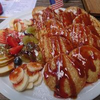 Mini pancakes and fruits wit strawberry sauce and caramel sauce at Pancake Am Tor in Munich