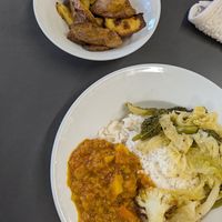 Root veg dhal, rice, roasted greens and potato wedges at Food Works Sharrow in Sheffield