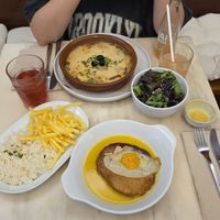 "V'acalhau com natas" with side salad and "Bitoque" with fries and rice. And kombucha at A Minha Avó in Lisbon