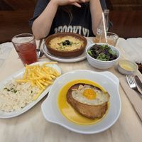 "V'acalhau com natas" with side salad and "Bitoque" with fries and rice. And kombucha at A Minha Avó in Lisbon