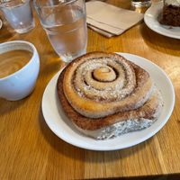 Cinnamon roll and flat white with oat milk  at Godt Brød in Bergen