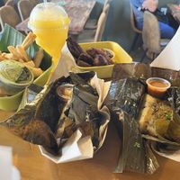 Clockwise from the top. Mango Aqua Fresca, Maduros, Mushroom Tamale, Black Bean Tamale, and Yuca Fries.  at Buen Provecho ABQ in Albuquerque
