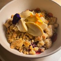 Berry crumble - with apples, pears, berries, and passion fruit at MUDRA Plant Based  in Madrid