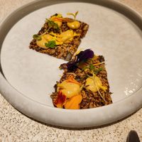 A cracker that was delicious at MUDRA Plant Based  in Madrid