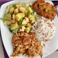 Rice with vermicelli, apple lettuce avocado salad, white beans with vegan sausage, fried potato and carrot fritter at Las Veganas in Medellin