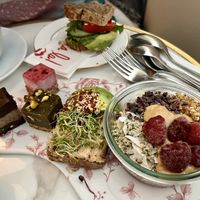 Brunch plate with oats, avocado open sandwich and mini cakes   at Oslo Raw Frogner in Oslo