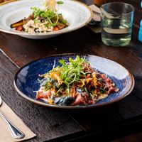 VEGAN CHARGRILLED EGG PLANT SALAD entrée and main size - roasted
aubergine, cherry tomato fregola salad garnished
with vegan mozzarella at Punk Pasta in London