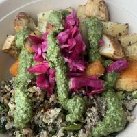 Everything potatoes, pesto drizzle, quinoa and kale base, Buffalo Impossible chicken, pickled cabbage.  at Florish in Tampa