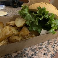 The potatoes look good, but not taste good. The lettuce is brown on the edges. Very dry burger.  at Goiko in Barcelona