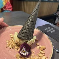 Delicious Peanut Butter Avo Ice Cream, vegan avo-peanutbutter ice serves with a black cone 5,95  at The Avocado Show in Leidschendam