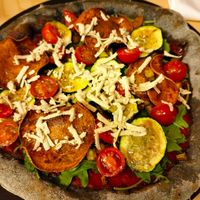 amazing pizza with charcoal dough, tomato sauce, rocket, crunchy sweet potatoes, zucchini, cherry tomatoes and homemade cashew cheese. at La Gastrobottega Di Giuseppe in Calpe