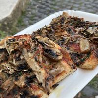 Vegan pizza with mushrooms and some herbs  at La Prezzemolina in Rome