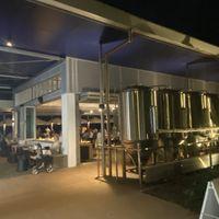 Restaurant w/ brewing equipment on the right and the river in the background   at Auckland House in Gladstone