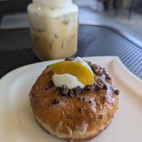 Cold latte & peach donut at Sabor A Vida Cafe & Deli in Vista
