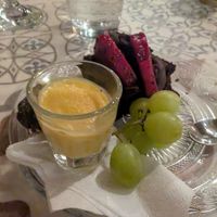 Amazing dessert of chocolate cake, fruit, and a Dubai truffle hiding behind the citrus gelato at O Linós in Paphos