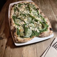 Vegan pizza with pesto, asparagus, green veg. Warning that the menu does not state that almonds come on top  at Di Marzano Cafe Vermuteria in Lisbon