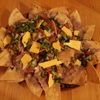 These are the Aztlan nachos with vegan cheese option.  The cheese isn't great. at Calavera Coyote Pulquería in Puebla