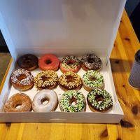 Dozen vegan donuts with drip coffee and almond milk at Angel Donuts and Treats in Austin
