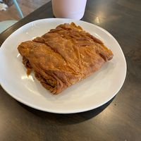 Vegan spanikopita, a Greek pastry with vegan cheese and spinach in layers of flakey pastry, heated when ordered for here. at Koupa Espresso Bar in Haddon Township