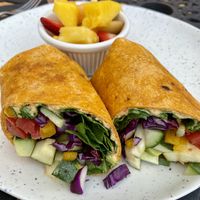 Vegan wrap with side of fresh fruit    at Shelf Indulgence Used Book Cafe in Sarasota