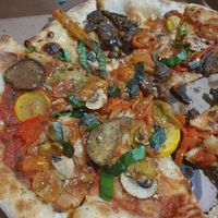 Vegan pizza with eggplant, mushrooms, tomato, bellpepprr, zucchini and basil. at Bella Italia in Jardin