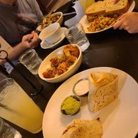 Breakfast burrito, chickpea tuna sandwich with curry rice, kale salad and in the center is a bowl of sticky cauliflower. at Botanical Plant-Based Fare in Charlottesville