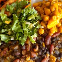 Rice and pea boiled down with coconut,  plantain,  channa with salad. at De Ultimate in Bridgetown