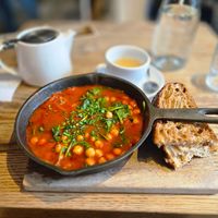 Vegan shakshouka soup with sourdough bread at SANDHOLT in Reykjavik