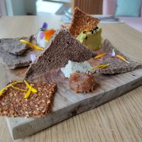 Cheese plate with 2 types of crackers (fennel and tomato), two different cheeses (one cashew, one sunflower) and a date paste. Yum! at Inward in Tunis