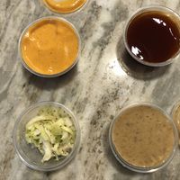 Twist sauce, Mumbo BBQ, vegan honey mustard, and slaw, all very tasty  at Twist Hot Chicken in Peoria