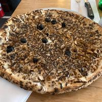 Vegan pizza with cremini mushrooms, olives, vegan sausage, and vegan cheese. at Motorino in New York City