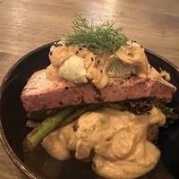 Salmon filet over potatoes with a dill sauce   at Meet Vegano in Malaga