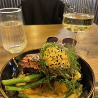 Vegan salmon on top of potatoes and broccolini   at Meet Vegano in Malaga