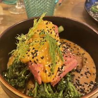 Salmon tofu on broccoli and potatoes in creamy sauce  at Meet Vegano in Malaga