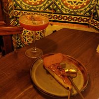 Lotus cheesecake and rosemary negroni cocktail at Meet Vegano in Malaga